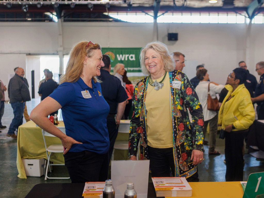 two women talking at a booth at the fair